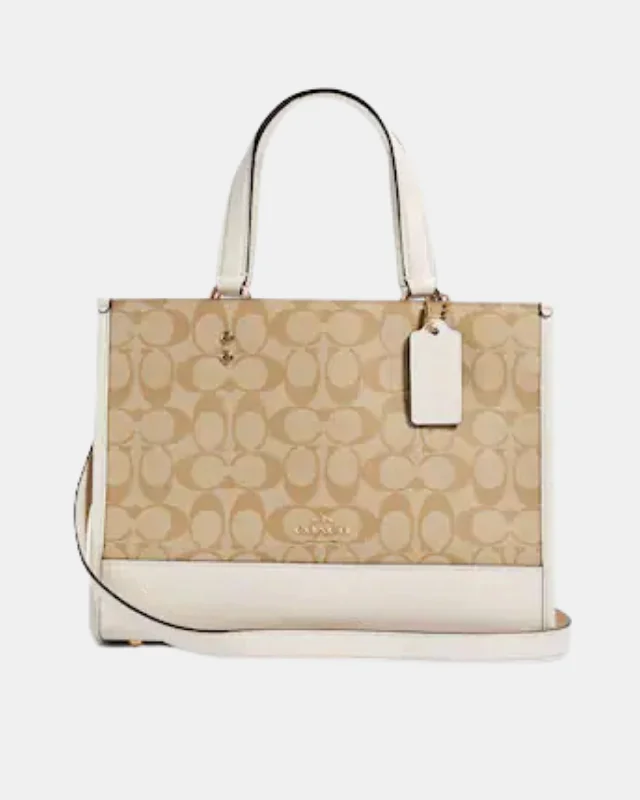 Coach Dempsey bags with a contrast - colored interior for visual interestCoach Dempsey Carryall In Signature Canvas