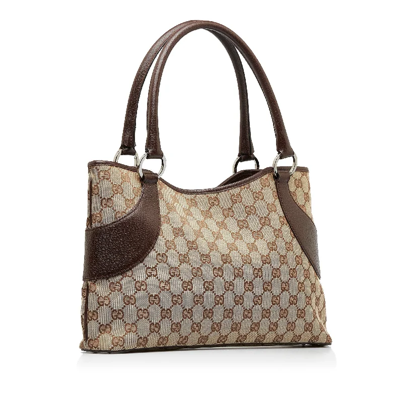 Women Gucci Sylvie bags featuring the signature web stripeGUCCI GG Canvas Shoulder Bag